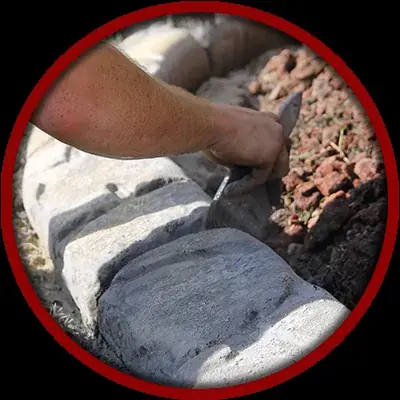 Finished concrete curbing holding back decorative rock
